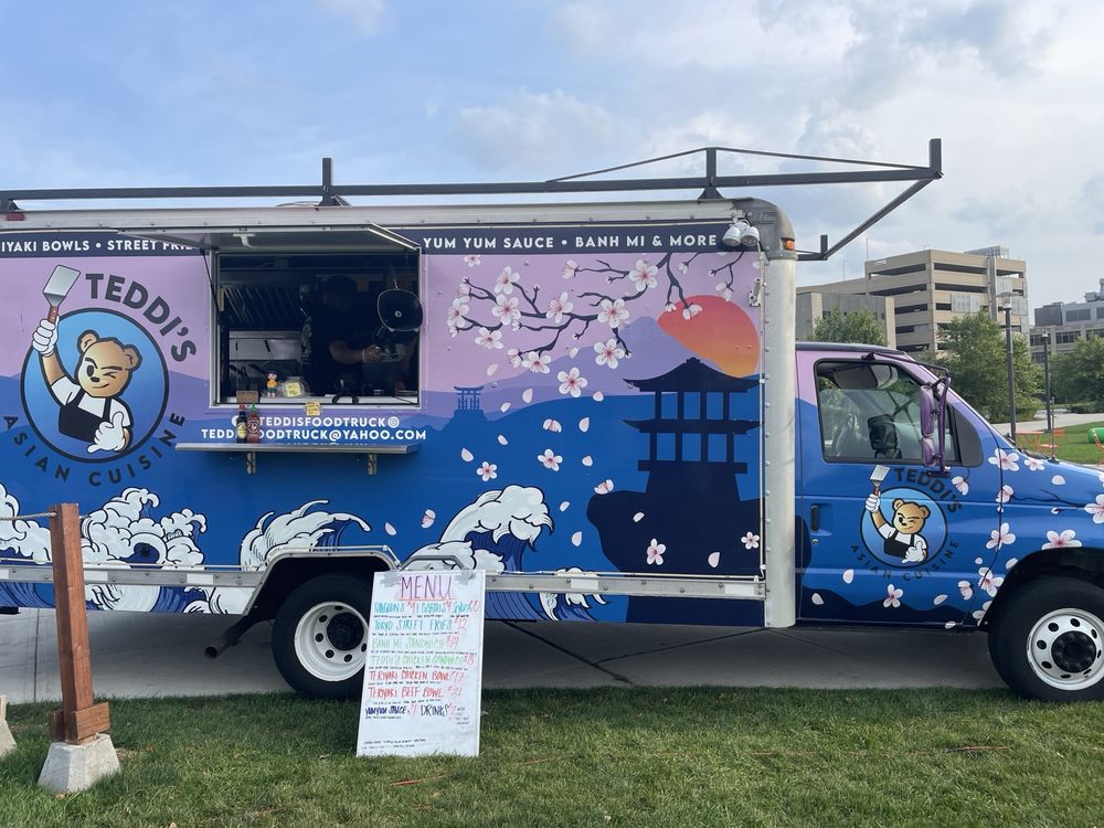 Teddi’s Food Truck featuring vibrant cherry blossom artwork, serving delicious Asian cuisine like teriyaki bowls, banh mi, and street fries.